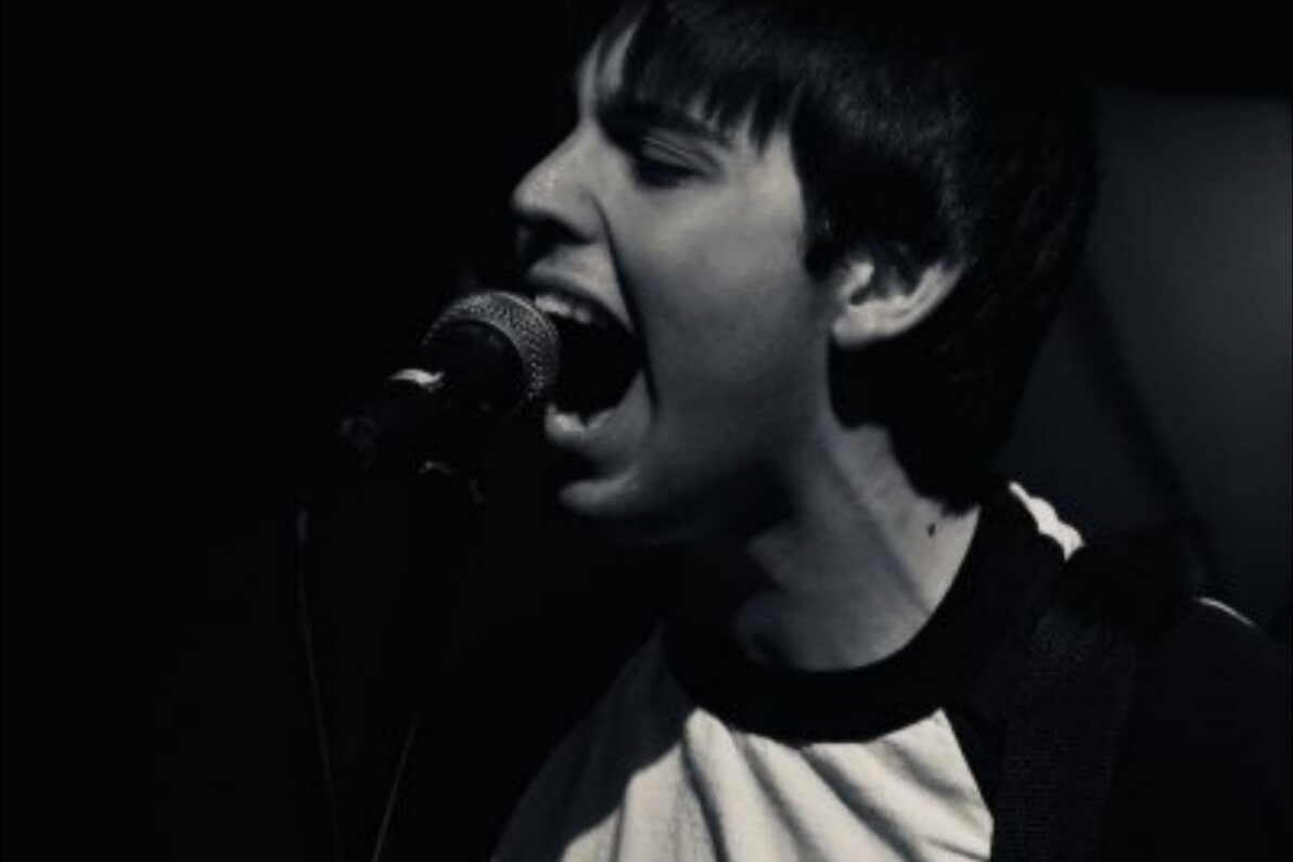 A singer at the microphone during a show, black and white