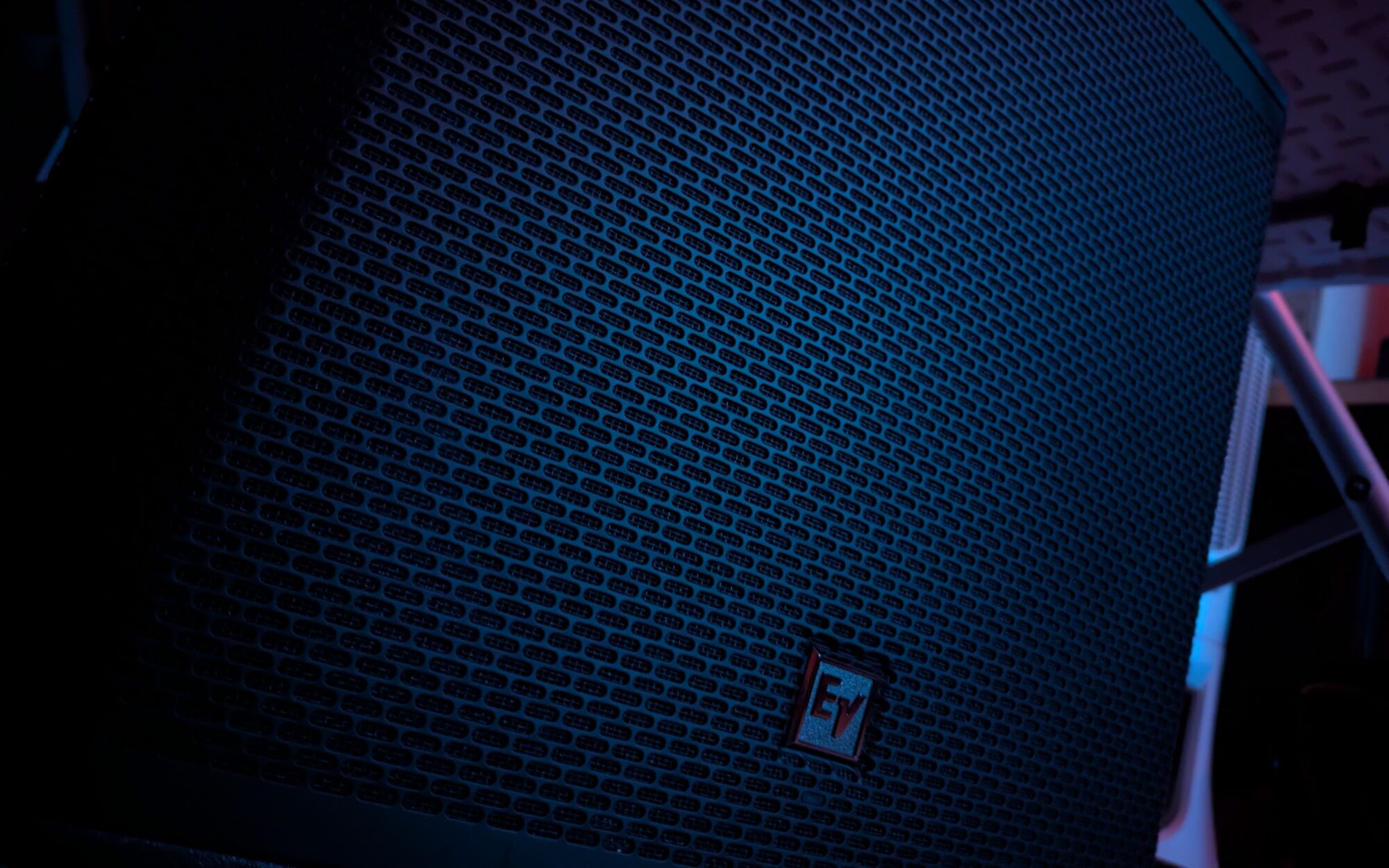 The grille of my subwoofer under blue light